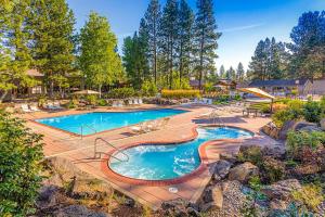 a large swimming pool in a yard with trees at Tranquil Pines at Seventh Mountain in Bend