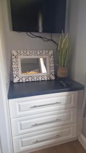 a dresser with a mirror on top of it at Shanadune in Tralee