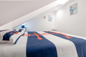 a white bedroom with a blue and orange bed at Seixal Yachting Bay Original in Seixal +60 photos
