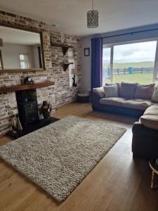 a living room with a couch and a fireplace at Shanadune in Tralee