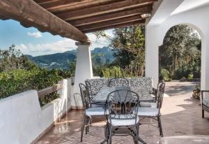 a table and chairs on a patio with a view at Villa Marinella in Barrabisa