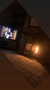 a tv in a room with a fire in it at Shanadune in Tralee