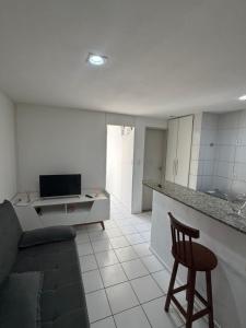 a kitchen with a couch and a chair in a room at Ap studio a 50m da praia in Maceió