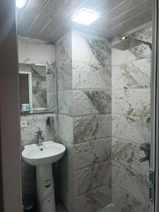 a bathroom with a sink and a mirror at Tevosyan Pluse Evn Airport in Pʼarakʼar