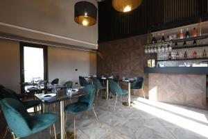 a restaurant with tables and chairs and a bar at Spera Luxury Palermo & SPA in Palermo