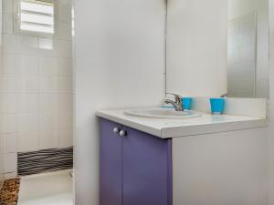 a bathroom with a sink and a mirror at villa Caraibes proche plage in Sainte-Anne +14 photos