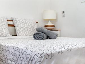 a bedroom with a bed with two pillows on it at villa Caraibes proche plage in Sainte-Anne