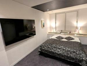 岸和田市にあるホテルサバナリゾートＡｄｕｌｔ Ｏｎｌｙのベッドルーム(ベッド1台、薄型テレビ付)