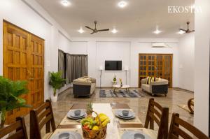 a living room with a table with bananas on it at EKOSTAY - Mercury Villa in Alibaug +8 photos