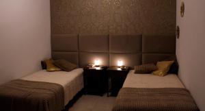 two beds in a room with two candles on them at Apartament z widokiem na morze 250 m od plaży in Torrevieja +22 photos