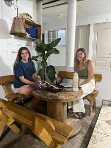 two women sitting at a table in a room at Hostal Villa Marta in Santa Ana
