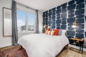 a bedroom with a large bed and a large window at Jude's Respite in Traverse City