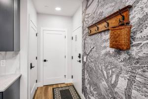 a hallway with a stone wall and a wicker basket on the wall at Jude's Respite in Traverse City +22 photos