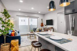a kitchen with a counter and a living room at Jude's Respite in Traverse City