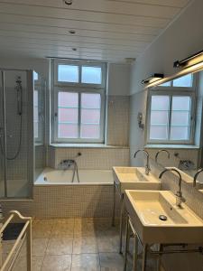 ein Badezimmer mit zwei Waschbecken und einer Badewanne in der Unterkunft Groot Huus in Norderney