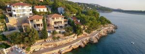 a group of houses on an island in the water at Oasis Premium Twin in Primošten