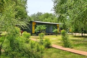 a house in the middle of a garden at SleepOver Komatipoort in Komatipoort +18 photos