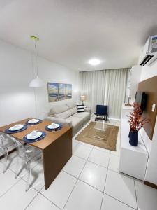 a living room with a table and a couch at Iloa Residence Ap 103 K Barra de São Miguel AL in Barra de São Miguel