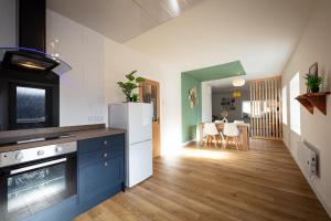 a kitchen with a refrigerator and a dining room at 9B Bayfield Road in Portree