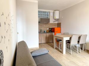 a living room and kitchen with a table and chairs at Casa Vacanza in Posizione Panoramica lago d'Iseo in Sarnico