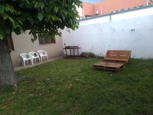 a picnic table and a bench in a yard at Casa chalet neco in Necochea