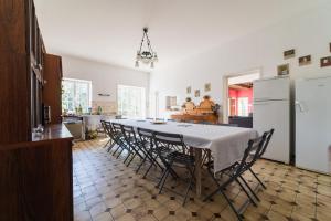 a dining room with a table and chairs in a kitchen at La Maison de Thérèse, Longère 15 people in Bonneuil-Matours