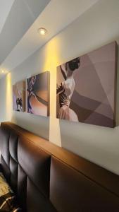 a living room with two pictures on the wall at SAMAY 122 - Acogedor Monoambiente muy cerca del centro! in Cochabamba