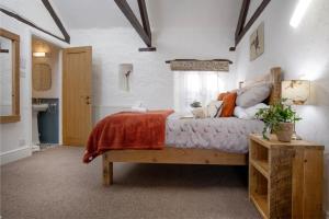 a bedroom with a large bed and a window at Mill Cottage in Paignton