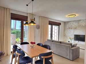 a living room with a table and a couch at Modern Villas at Perla Resort in Durrës