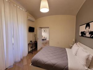a bedroom with a bed and a room with a table at Home Vaticano 50 steps from Museum in Rome