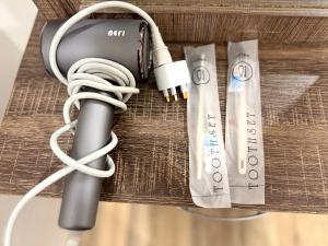 a charger and headphones sitting on a table at Gala City CornerApt Gala residence in Kuching