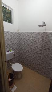 a bathroom with a toilet and a sink at Senja Kelabu Homestay in Kampong Bukit Tok Beng