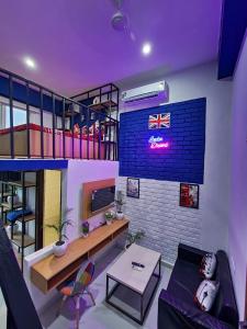 a living room with a couch and a brick wall at Zen Haven - Luxury Ganga Access & Mountain View in Rishīkesh +33 photos