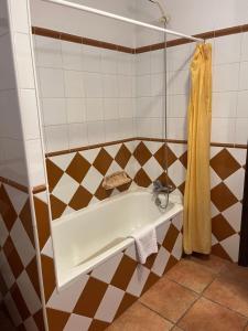a bathroom with a bath tub with a sink at Casa Rural Nelia in Villalba de la Sierra +14 photos