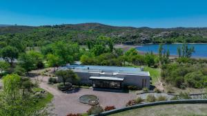 an aerial view of a house with a lake at Casa entre pinos in La Florida