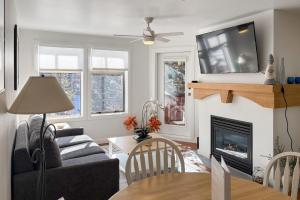 a living room with a couch and a fireplace at Eagle Springs East 304: Josephine's Suite in Solitude