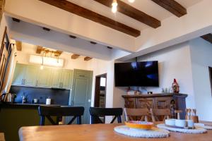 a kitchen and dining room with a table and chairs at Трите къщи in Leshten