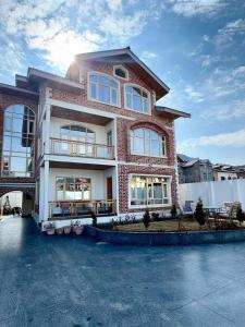 a large brick building with the sun behind it at Dream Stays in Nārachpur +23 photos