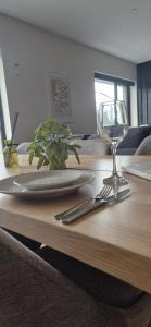 a table with a plate and a wine glass on it at Sleek modern design - 2 bed apartment in Donegal Town in Donegal +13 photos