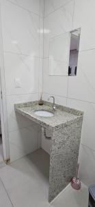 a bathroom with a sink and a mirror at Hotel Real in Ouro Preto