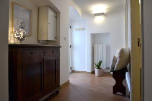 a kitchen with a wooden dresser in a hallway at Dimora il Capitello in Cisternino +21 photos
