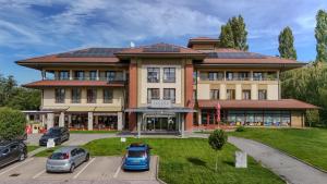 a large building with solar panels on the roof at Hotel Legend in Dunajská Streda