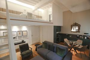 a living room with a couch and a bunk bed at Bargello Nine Luxury Suite in Florence +43 photos