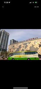 a green bus parked in front of a building at Skytrees 公寓 距Aeon五分钟路程 in Johor Bahru