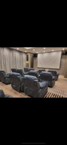 a large room with couches and a projection screen at Skytrees 公寓 距Aeon五分钟路程 in Johor Bahru
