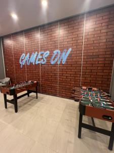 a room with two tables and a sign that reads games on at Skytrees 公寓 距Aeon五分钟路程 in Johor Bahru