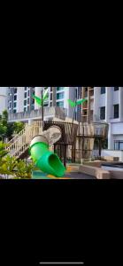 a playground with a green slide in front of a building at Skytrees 公寓 距Aeon五分钟路程 in Johor Bahru