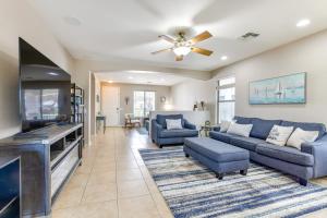 a living room with two blue couches and a flat screen tv at Pool, Patio and Grill San Tan Valley Escape! in Queen Creek