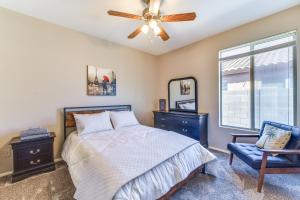 a bedroom with a bed and a ceiling fan and a chair at Pool, Patio and Grill San Tan Valley Escape! in Queen Creek +17 photos