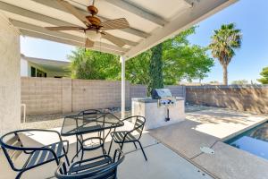 a patio with chairs and a table with a ceiling fan at Pool, Patio and Grill San Tan Valley Escape! in Queen Creek